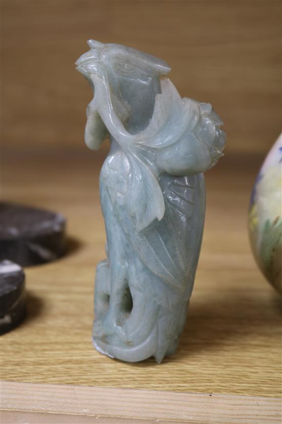 A Chinese celadon jade magnolia blossom, a jadeite figure of Guanyin, a pair of jadeite birds, a large soapstone figure of a lady and a